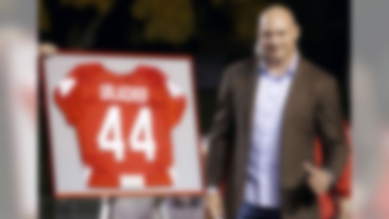 Former New Mexico and Chicago Bears football player Brian Urlacher gives a thumbs up as his jersey number is retired during a halftime ceremony at an NCAA college football game against the Air Force on Friday, Nov. 8, 2013, in Albuquerque, N.M. (AP Photo/Ross D. Franklin)