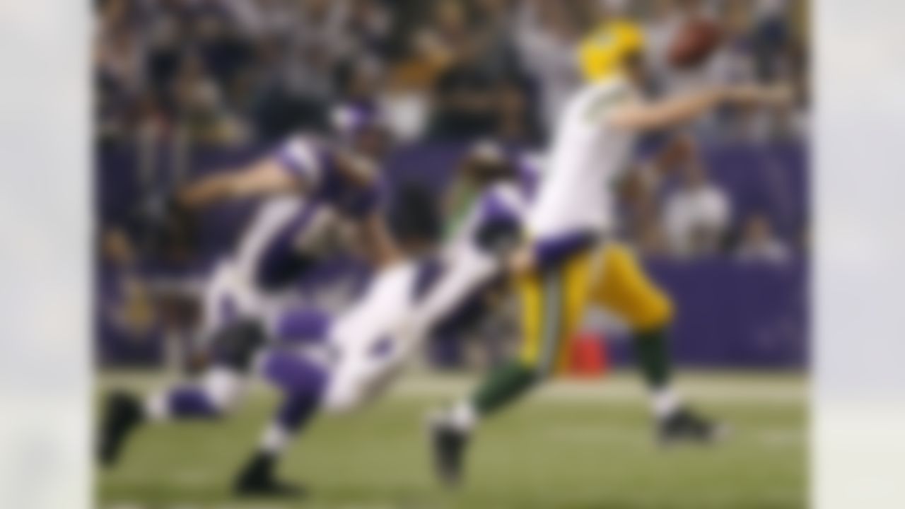 Green Bay Packers quarterback Aaron Rodgers, right, fumbles the ball as he is hit by Minnesota Vikings defensive end Brian Robison during the second half of an NFL football game Sunday, Dec. 30, 2012, in Minneapolis. (AP Photo/Genevieve Ross)