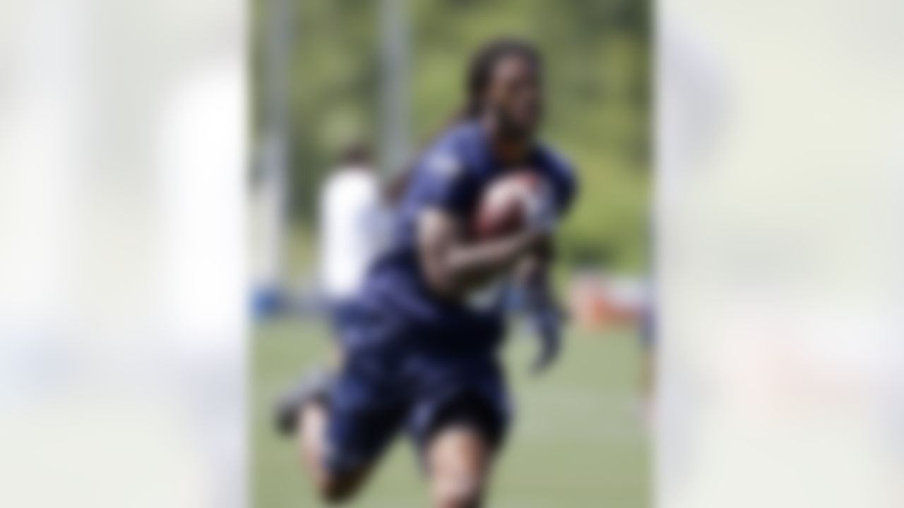 Seattle Seahawks' Sidney Rice runs with the ball at an NFL organized team activity football practice Monday, June 2, 2014, in Renton, Wash. (AP Photo/Elaine Thompson)
