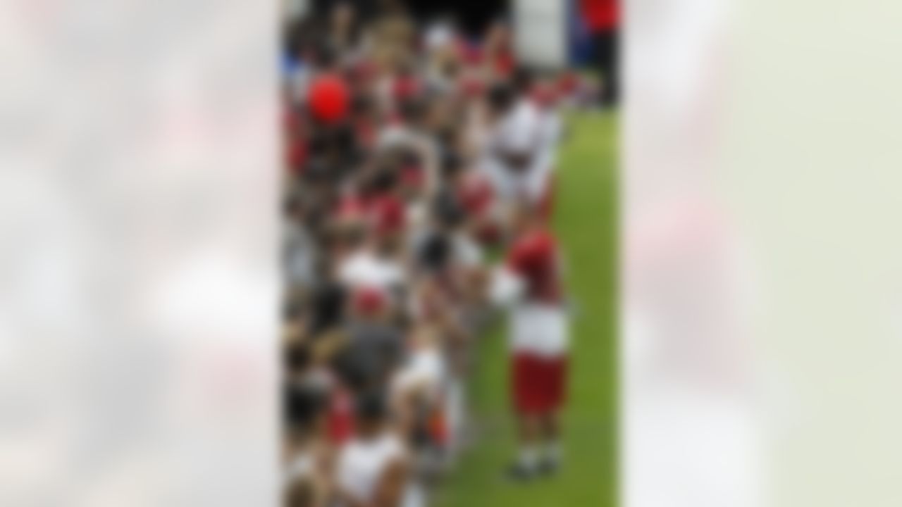 Arizona Cardinals' Paul Vassallo (48) and fellow players sign autographs for fans after NFL football training camp at Northern Arizona University, Thursday, July 26, 2012, in Flagstaff, Ariz. (AP Photo/Ross D. Franklin)