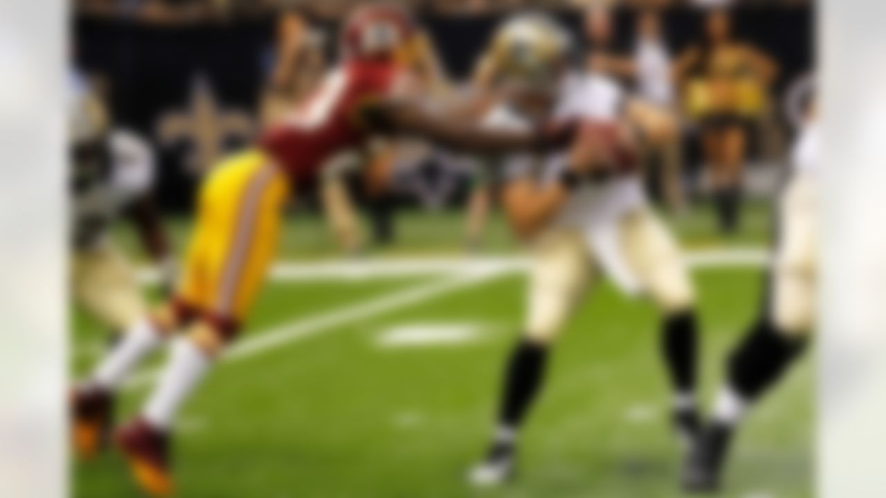 New Orleans Saints quarterback Drew Brees (9) is sacked by Washington Redskins cornerback DeAngelo Hall (23) in the first half of an NFL football game at the Mercedes-Benz Superdome in New Orleans, Sunday, Sept. 9, 2012.