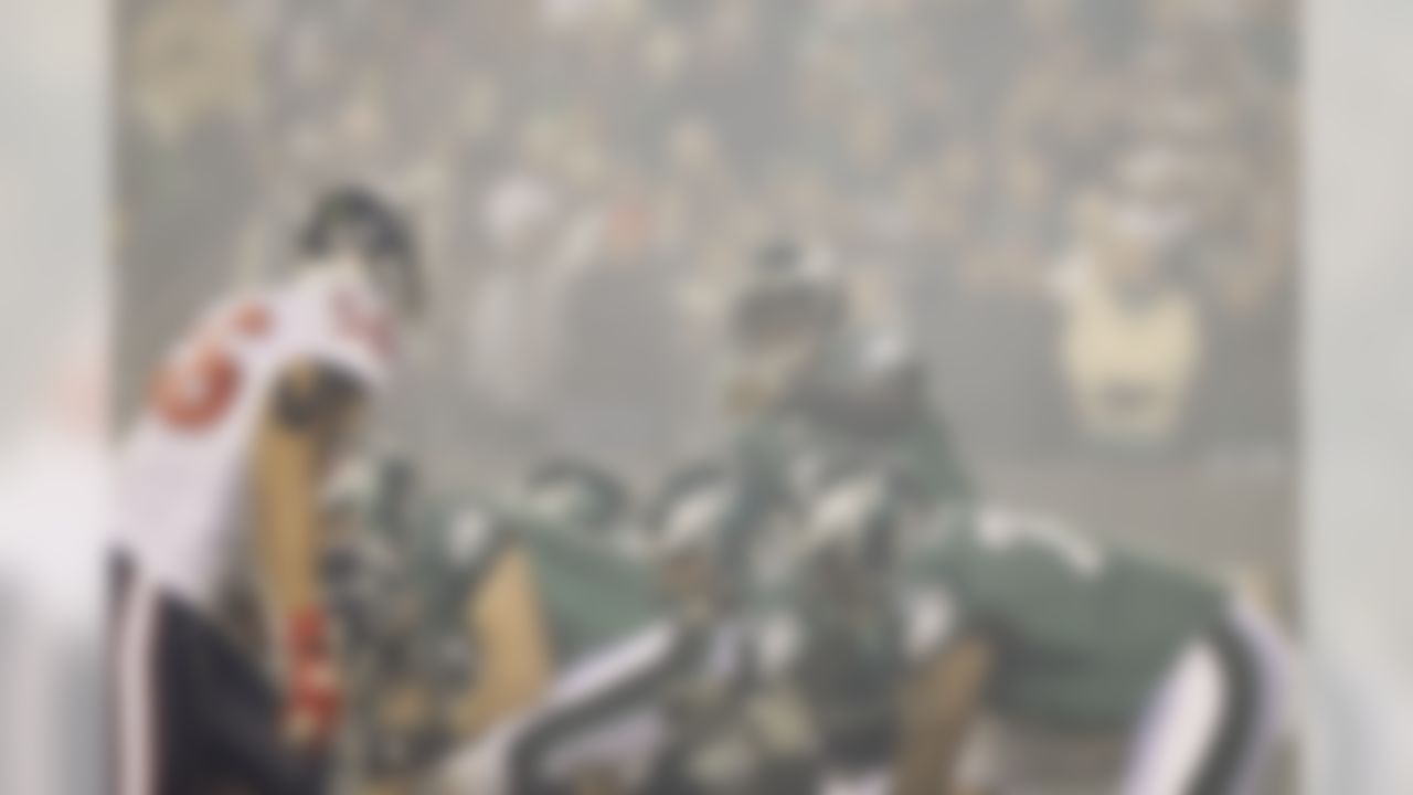 Philadelphia Eagles' Michael Vick (7) points out coverage in a haze of fireworks smoke in the first half of an NFL football game against the Houston Texans, Thursday, Dec. 2, 2010 in Philadelphia. (AP Photo/Matt Slocum)