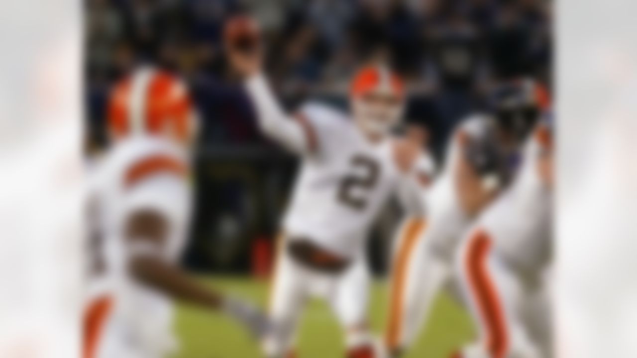 Cleveland Browns quarterback Tim Couch passes under pressure from Baltimore Ravens linebacker Peter Boulware, right, in the second quarter in Baltimore, Sunday, Dec. 22, 2002. Couch capped a frantic drive with a 1-yard touchdown pass to Browns tight end Mark Campbell with 29 second remaining to help lift the Browns to a 14-13 win. (AP Photo/Roberto Borea)