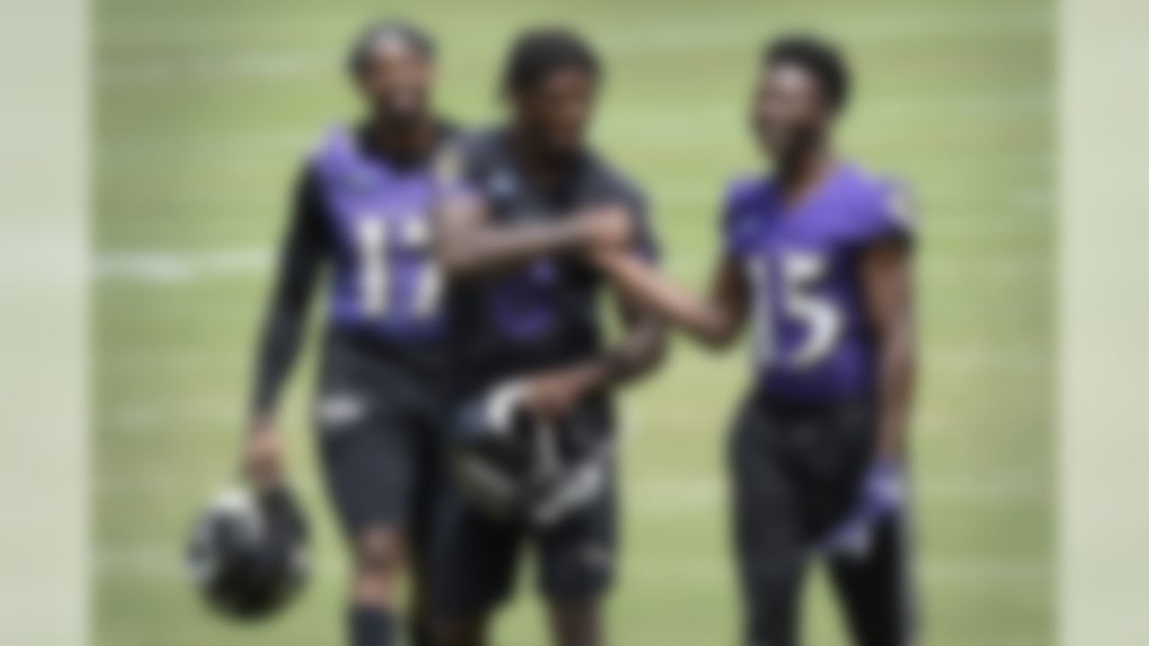 Baltimore Ravens quarterback Lamar Jackson, center, shakes hands with Marquise Brown after workouts at the team's NFL football training facility in Owings Mills, Md., Wednesday, June 12, 2019.