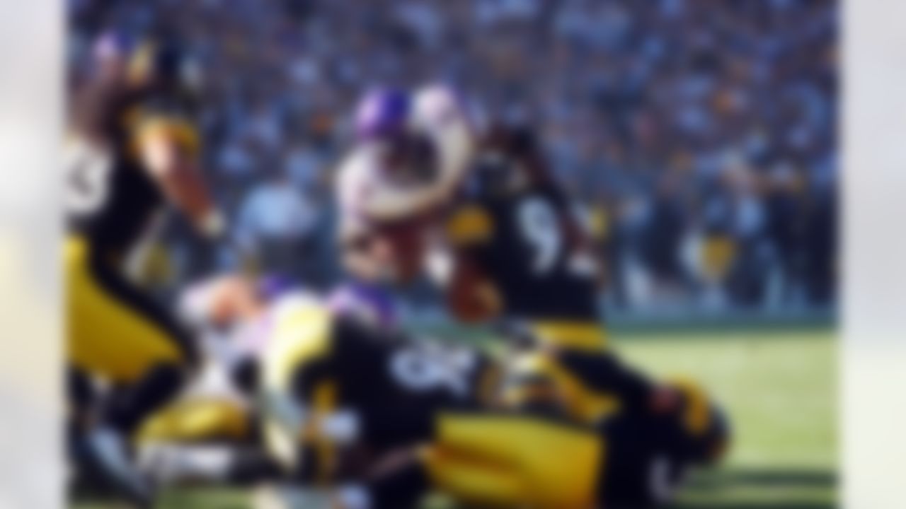 Minnesota Vikings running back Adrian Peterson (28) tries in vain to dive for a touchdown while being tackled by Pittsburgh Steelers linebacker James Harrison (92) during the NFL football game, October 25, 2009 in Pittsburgh, Pennsylvania. The Steelers won the game 27-17. (AP Photo/Paul Spinelli)