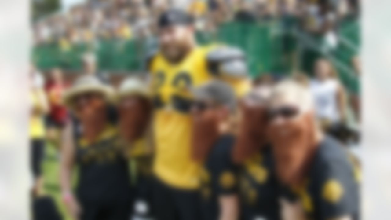 Pittsburgh Steelers defensive end Brett Keisel (99) takes a break during practice to visit with a group of fans that call themselves "Brett's Bearded Beauties" that made their way to the NFL football training camp in Latrobe, Pa. on Saturday, July 28, 2012. The women, from left to right are, Bonnie Liska, Beth Elder, Dawn Conley, Christine Taylor, and Poppy Pritchett. (AP Photo/Keith Srakocic)