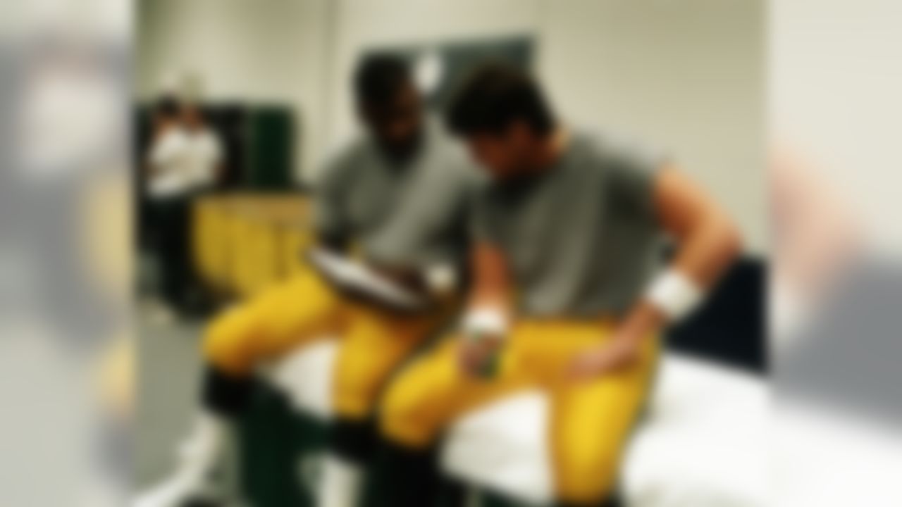 Green Bay Packers Hall of Fame defensive end Reggie White (92) shares Bible scripture with quarterback Brett Favre (4) before the 1995 NFC Championship Game against the Dallas Cowboys, Jan. 14, 1996. (AP Photo/Jim Biever)