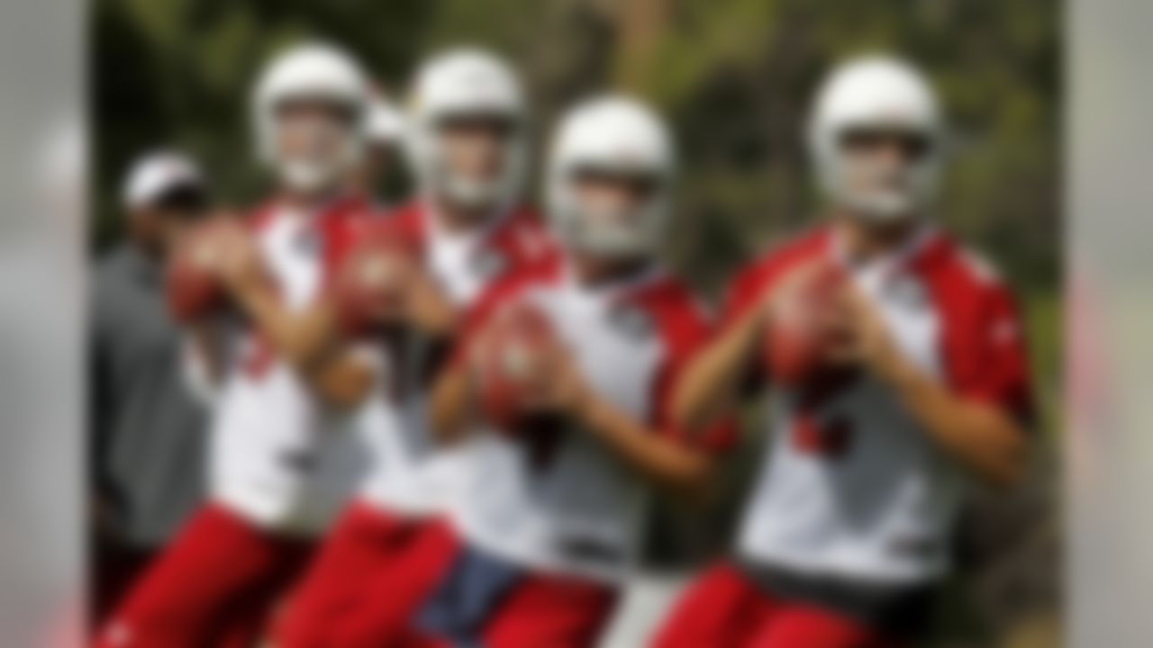From left to right, Arizona Cardinals quarterbacks John Skelton, Ryan Lindley, Kevin Kolb, and Richard Bartel drop back to throw passes during the first day of NFL training camp football practice at Northern Arizona University, Wednesday, July 25, 2012, in Flagstaff, Ariz. (AP Photo/Ross D. Franklin)