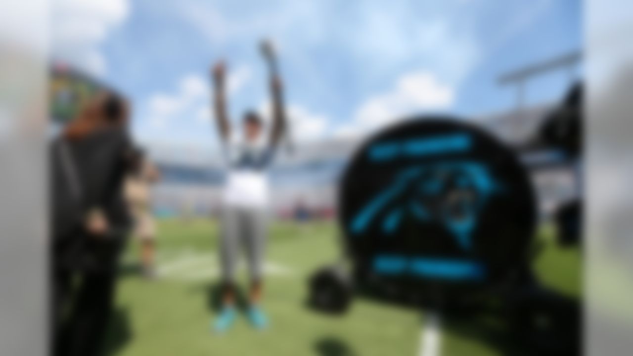 Golden State Warriors player and 2015 NBA MVP Stephen Curry prepares to "pound the drum" on the sideline of an NFL football game between the Carolina Panthers and the Houston Texans in Charlotte, N.C., Sunday, Sept. 20, 2015. (Perry Knotts/NFL)