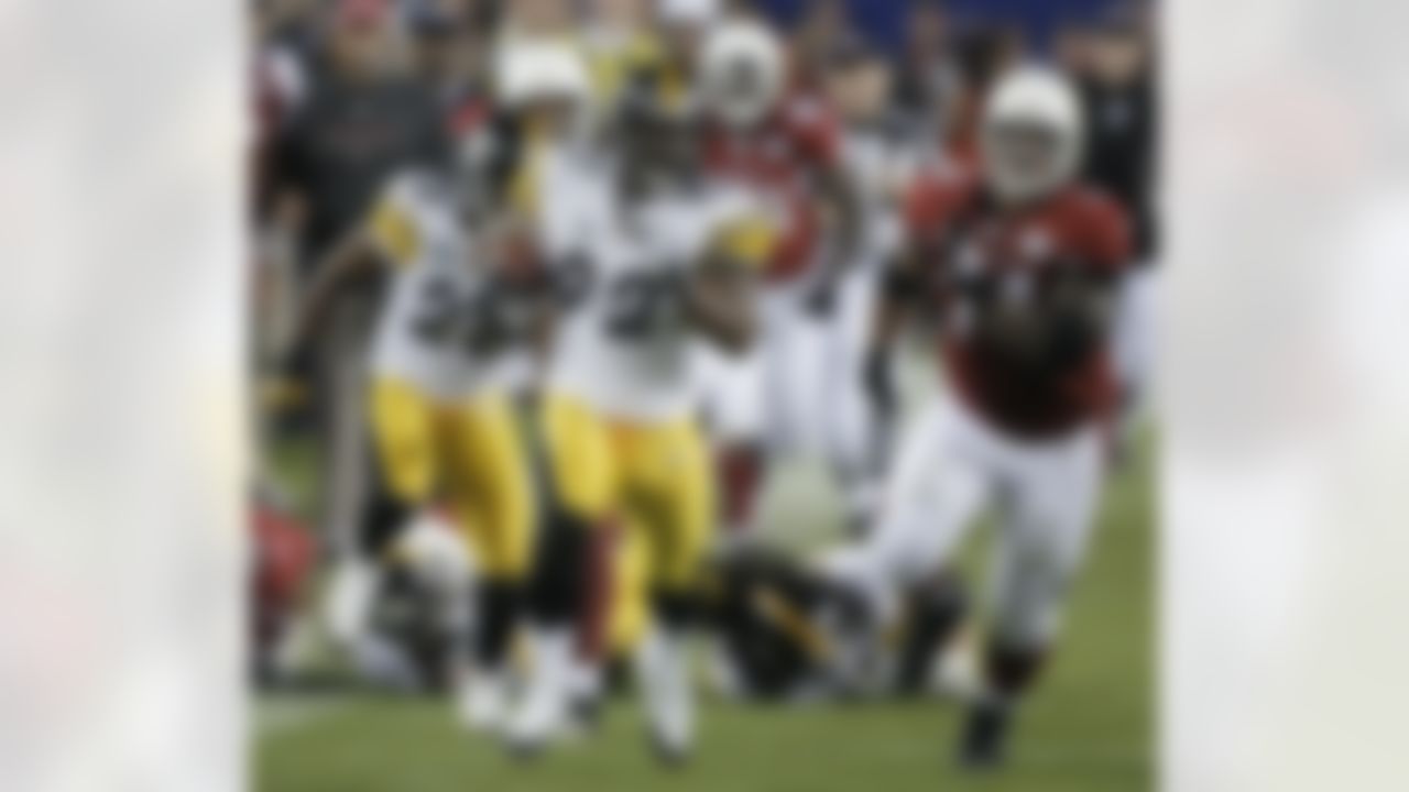 Pittsburgh Steelers linebacker James Harrison returns an interception for a 100-yard touchdown during the second quarter of the NFL Super Bowl XLIII football game, Sunday, Feb. 1, 2009, in Tampa, Fla. At right is Arizona Cardinals guard Reggie Wells. (AP Photo/John Bazemore)