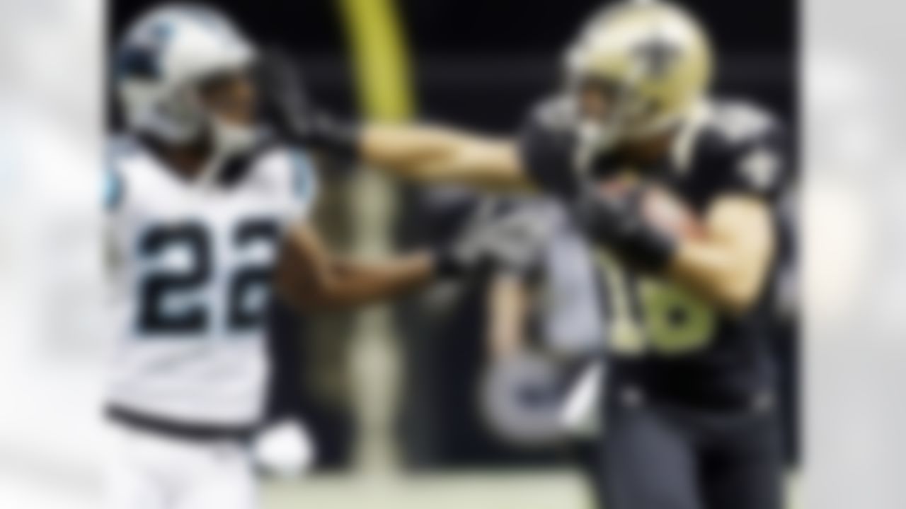 New Orleans Saints' Lance Moore gives Carolina Panthers' Josh Thomas (22) a stiff arm after catching a pass during the first half of an NFL football game Sunday, Dec. 30, 2012, in New Orleans. (AP Photo/Dave Martin)