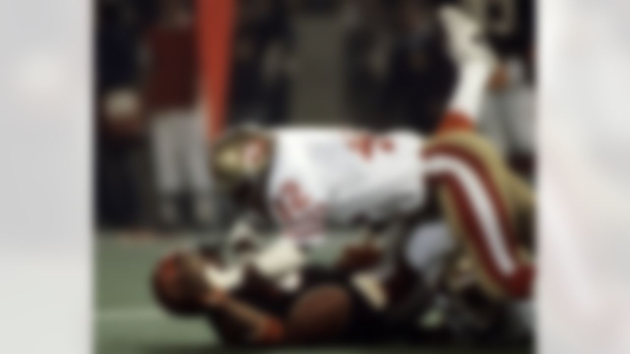 San Francisco 49ers Hall of Fame cornerback Ronnie Lott (42) dives over Cincinnati Bengals wide receiver Cris Collinsworth (80) trying to retrieve Collinsworth's fumble during Super Bowl XVI, a 26-21 49ers victory on January 24, 1982, at the Pontiac Silverdome in Pontiac, Michigan. The fumble was eventually recovered by 49ers defensive back Lynn Thomas. (Manny Rubio/NFL Photos)