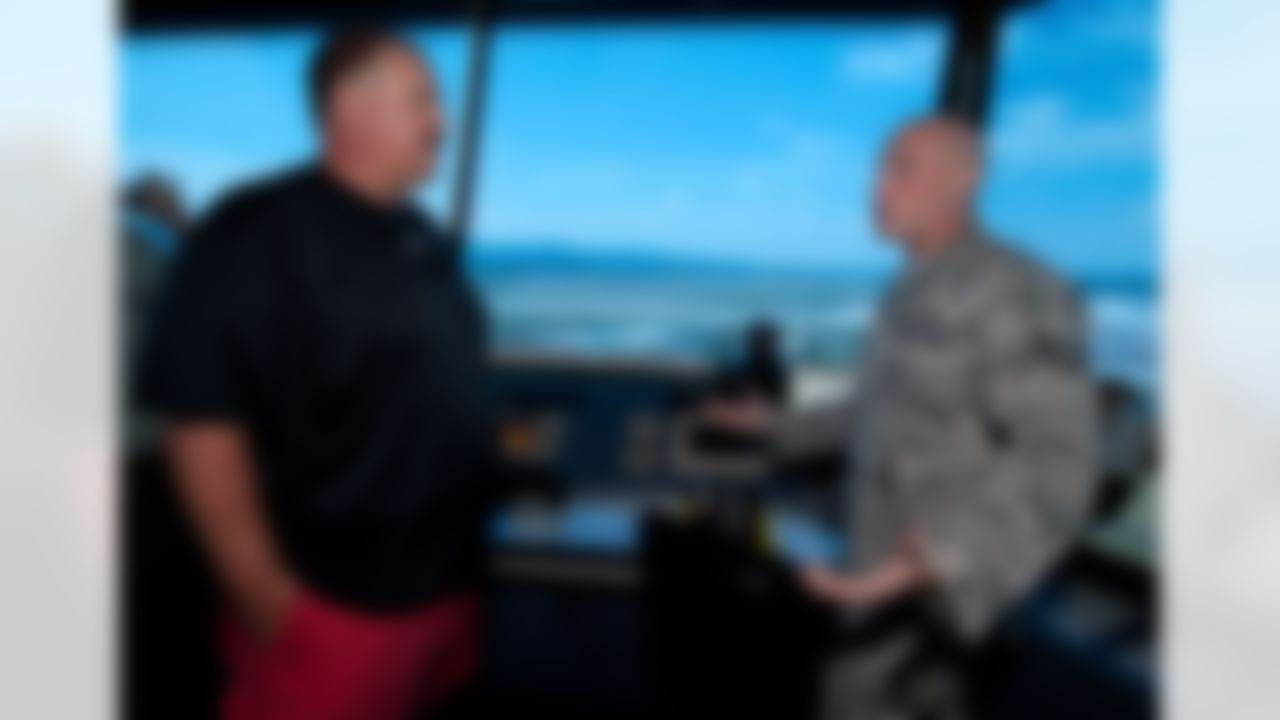 Philadelphia Eagles head coach Andy Reid visits with an airman in the air traffic control tower at Ramstein Air Base in Germany during a USO/Armed Forces Entertainment tour stop on June 30, 2010. This is Reid's first tour and he is joined by three other top NFL coaches who are touring bases in Germany and the Persian Gulf. (Fred Greaves/USO)