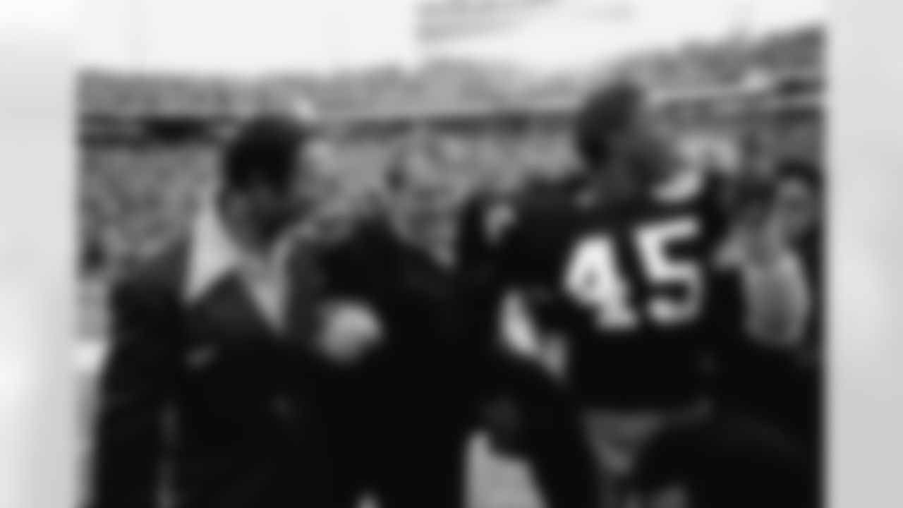 * FILE * In this Jan. 18, 1976, file photo, Pittsburgh Steelers coach Chuck Noll, center, leaves the field with Jim Allen (45) who holds up his finger indicating the Steelers are No. 1 after defeating the Dallas Cowboys 21-17 in Super Bowl X at the Orange Bowl in Miami. Now that Pittsburgh is headed to its seventh Super Bowl, each of the Steelers' three coaches in the last 40 years has taken them there. Noll first got there in his sixth season in 1974, Bill Cowher in his fourth. Mike Tomlin needed only two years after unexpectedly being hired for one of the best-known coaching jobs in American pro sports. (AP Photo/Phil Sandlin, File)