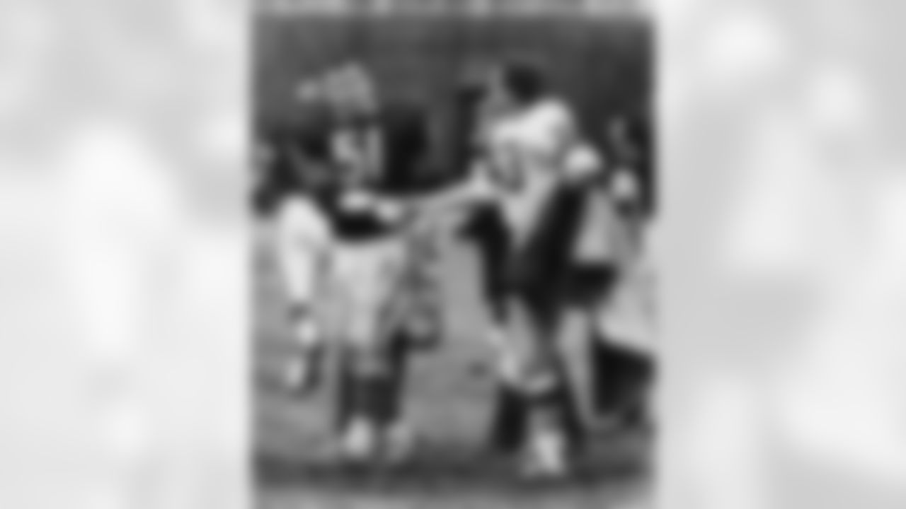 Dick Butkus (51) of the Chicago Bears shaking hands with Jim Grabowski of the Green Bay Packers after their game in Chicago on Nov. 27, 1967. Butkus and Grabowski were teammates at the University of Illinois. This Sunday, when the Bears and Packers meet for the 182nd time, they will play for the Halas Trophy in the NFC Championship. (AP Photo/Charles Harrity)