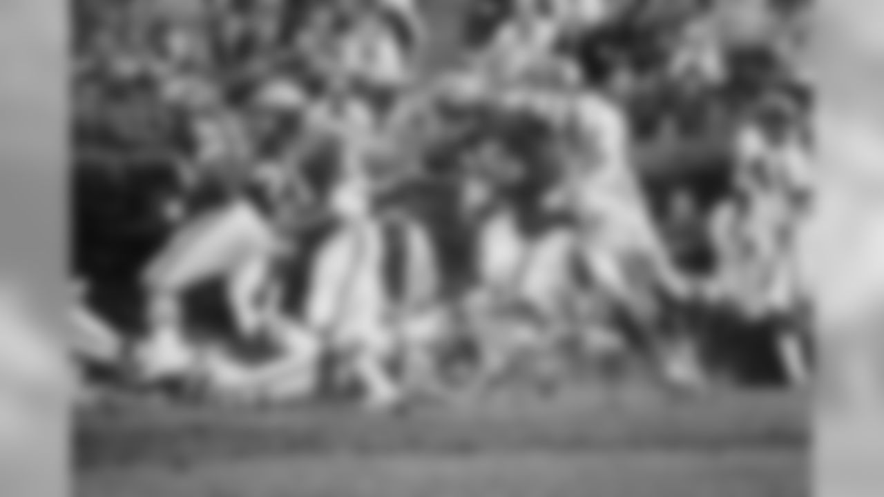 Kansas City quarterback Len Dawson is grabbed by a Minnesota defender after handing off to running back Mike Garett during first half action in the Super Bowl in New Orleans on Jan. 11, 1970. Garrett scored a touchdown on the play. (Associated Press)