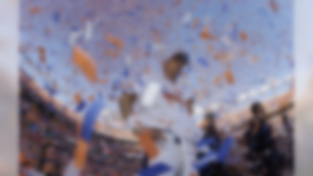 Denver Broncos quarterback Peyton Manning is engulfed in confetti during the trophy ceremony after the AFC Championship NFL playoff football game in Denver, Sunday, Jan. 19, 2014. The Broncos defeated the Patriots 26-16 to advance to the Super Bowl. (AP Photo/Charlie Riedel)