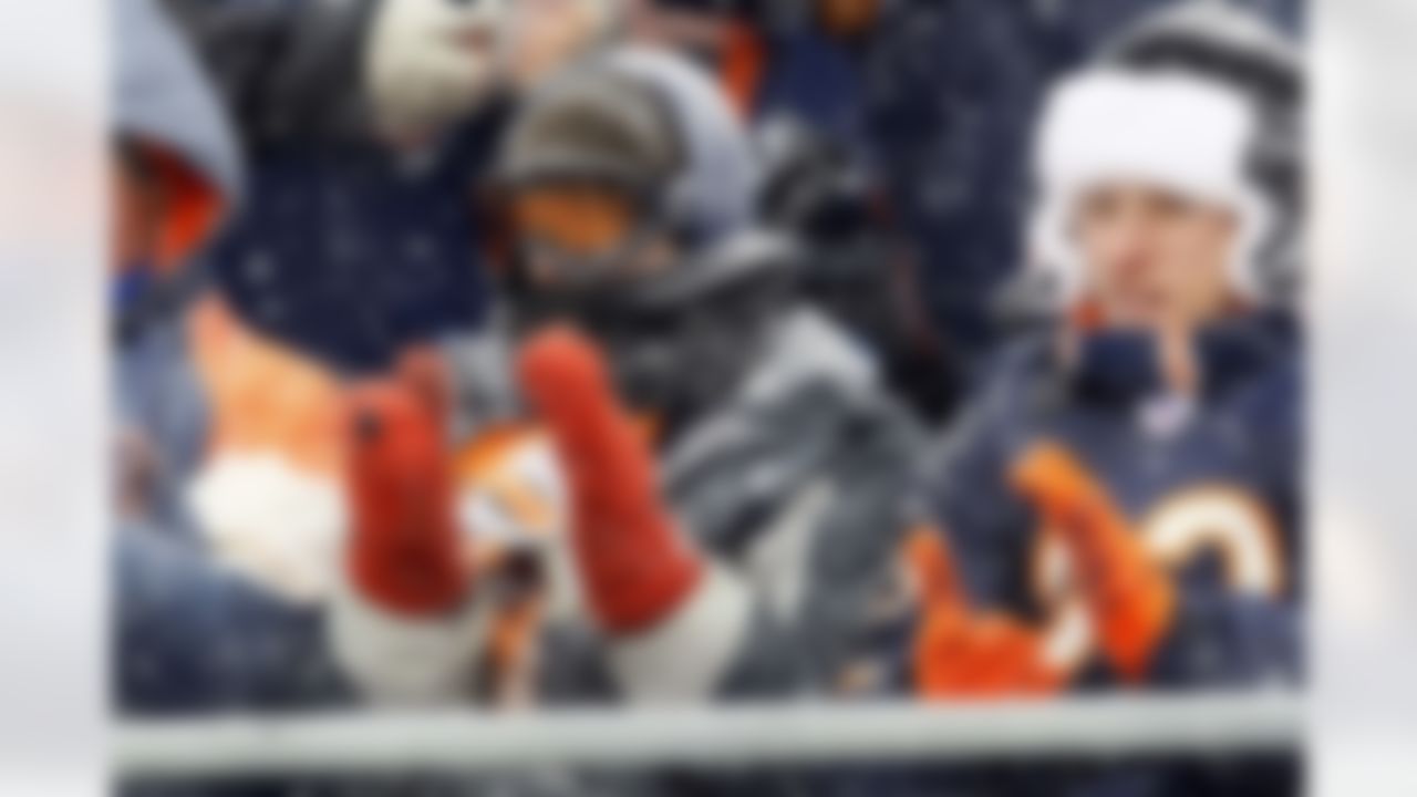 Chicago Bears fans are bundled up during a snowstorm in the first half of an NFL football game between the Chicago Bears and the New England Patriots in Chicago, Sunday, Dec. 12, 2010. (AP Photo/Charles Rex Arbogast)