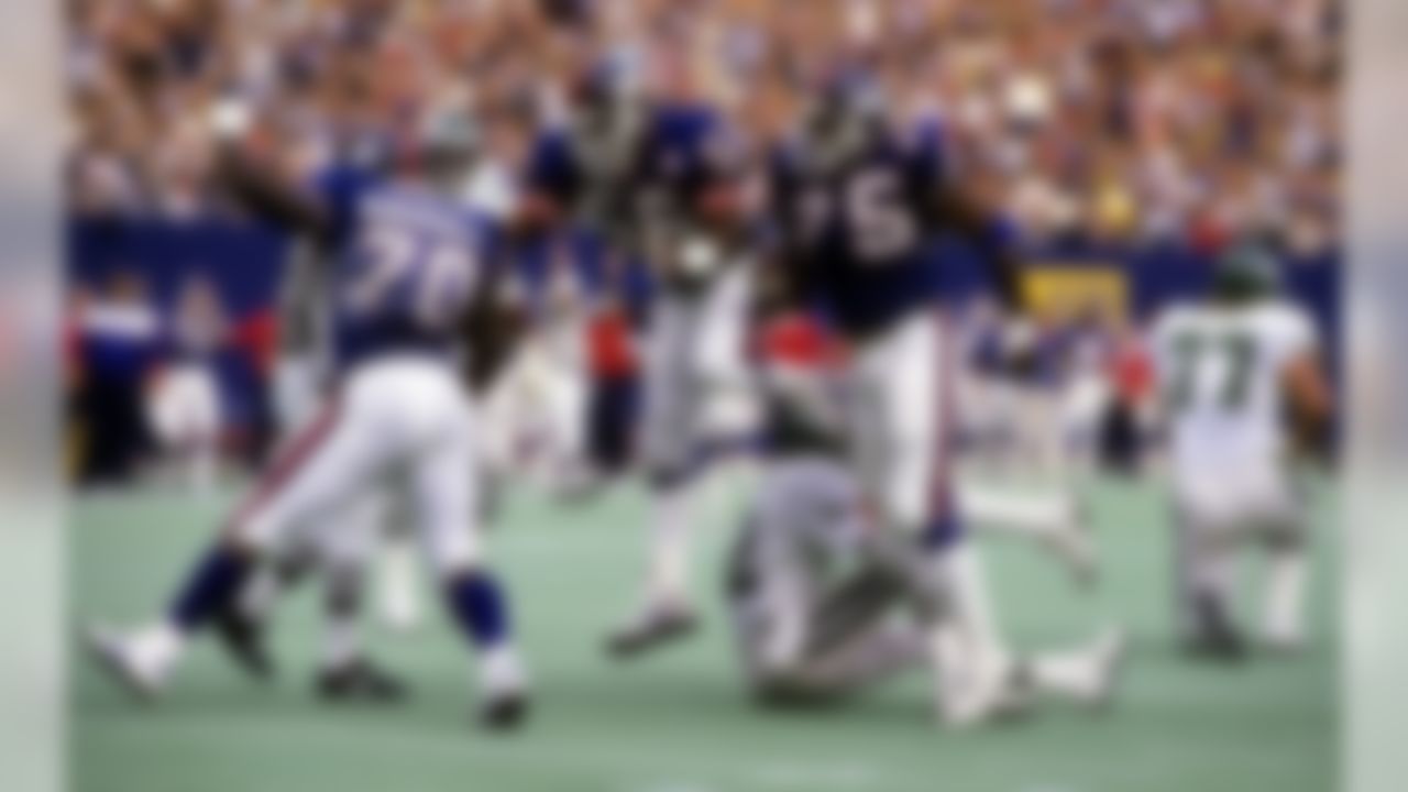 New York Giants defensive players Lawrence Taylor, George Martin, and Leonard Marshall celebrate a sack of Philadelphia Eagles quarterback Randall Cunningham during the Giants 35-3 victory over the Eagles on October 12, 1986 at Giants Stadium in East Rutherford, New Jersey. (Photo by Takashi Makita/NFL Photos)