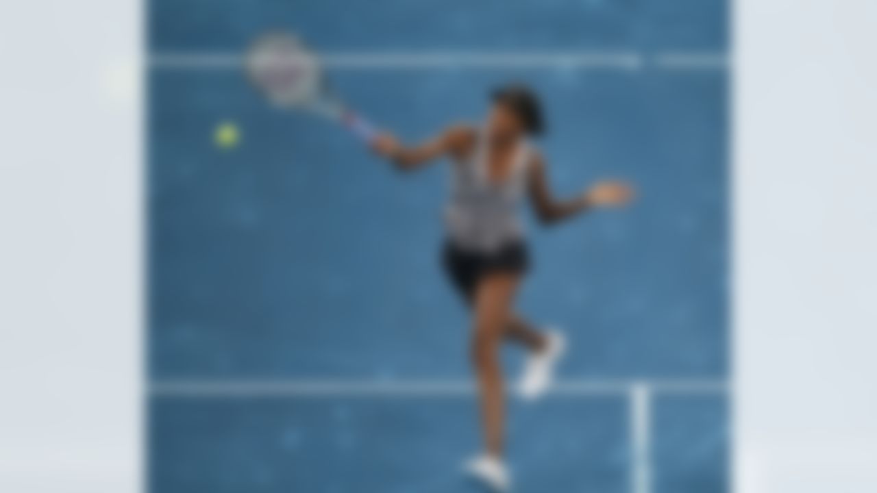 Venus Williams returns the ball during a Madrid Open tennis tournament match against Angelique Kerber from Germany, in Madrid, Monday, May 7, 2012. (AP Photo/Andres Kudacki)