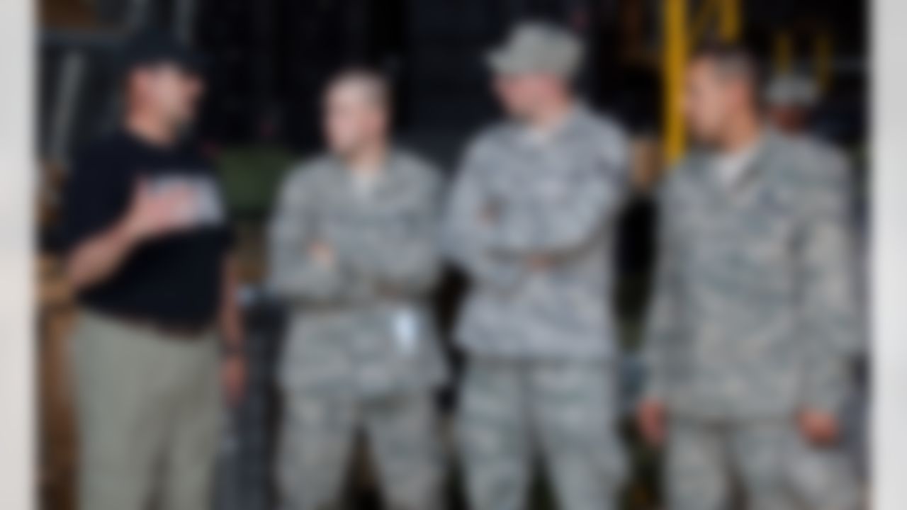 Minnesota Vikings head coach Brad Childress (l) talks with airmen at the 435th Air Mobility Squadron at Ramstein Air Base in Germany during a USO/Armed Forces Entertainment tour stop on June 30, 2010. This is Childress' first overseas USO tour and he is joined by three other top NFL coaches who are touring bases in Germany and the Persian Gulf. (Fred Greaves/USO)