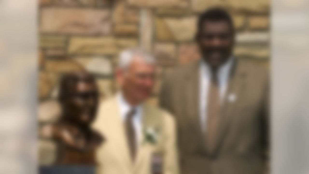 Pittsburgh Steelers President Dan Rooney, center, stands with his presenter, Joe Greene, after Rooney was enshrined in the Pro Football Hall of Fame Saturday, July 29, 2000, in Canton, Ohio. (AP Photo/Mark Duncan)