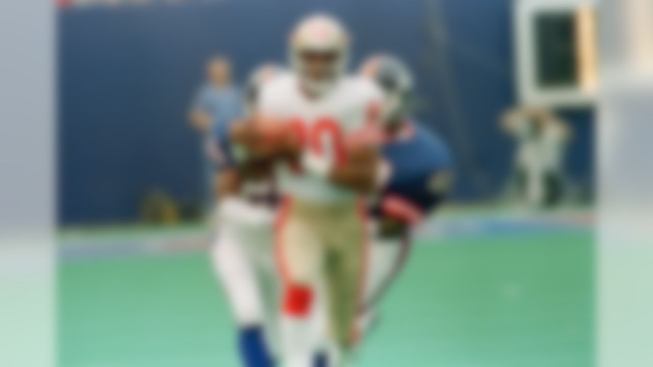 San Francisco 49ers wide receiver Jerry Rice heads for the end zone as he is chased by New York Giants Mark Collins, left, and Kenny Hill, right, on a 78-yard pass play from Joe Montana, to beat the Giants 20-17 with 42 second left in the game, Sept. 11, 1988 in East Rutherford, N.J. at Giants Stadium. (AP Photo/Hal Brown)