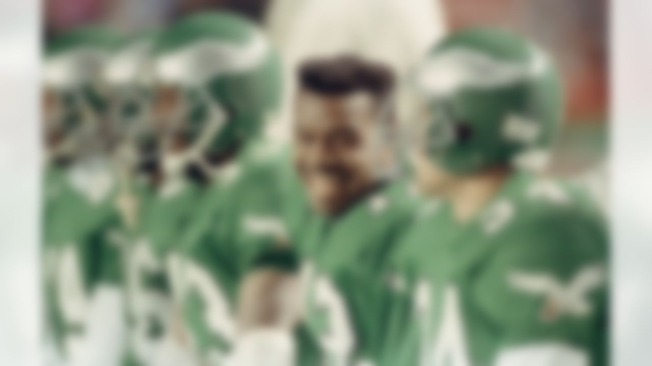 Philadelphia Eagles quarterback Randall Cunningham laughs with teammates on the bench in the closing minutes of the Eagles 28-14 win over the Washington Redskins at Philadelphia's Veterans Stadium, Nov. 13, 1990. Cunningham threw for 132 yards and one touchdown as well as rushing for 42 yards on 5 carries. (AP Photo/Rusty Kennedy)