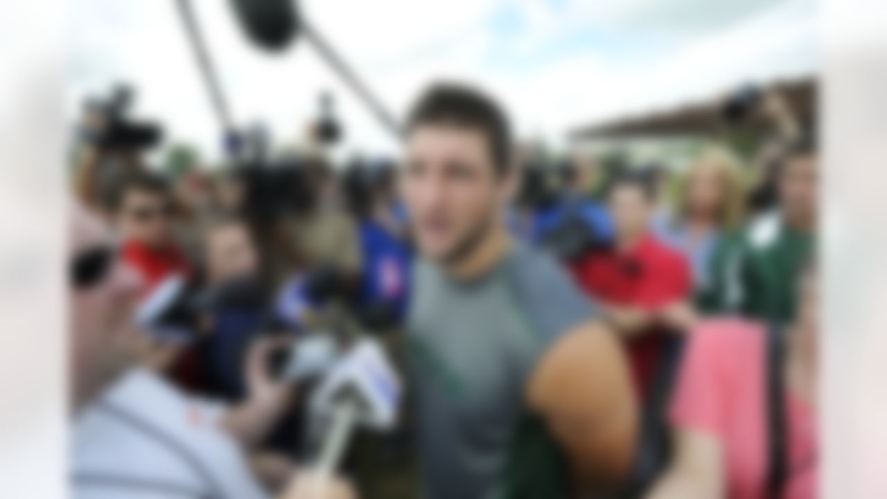 New York Jets quarterback Tim Tebow talks to the media after practice on opening day of their NFL football training camp Friday, July 27, 2012, in Cortland, N.Y. (AP Photo/Bill Kostroun)