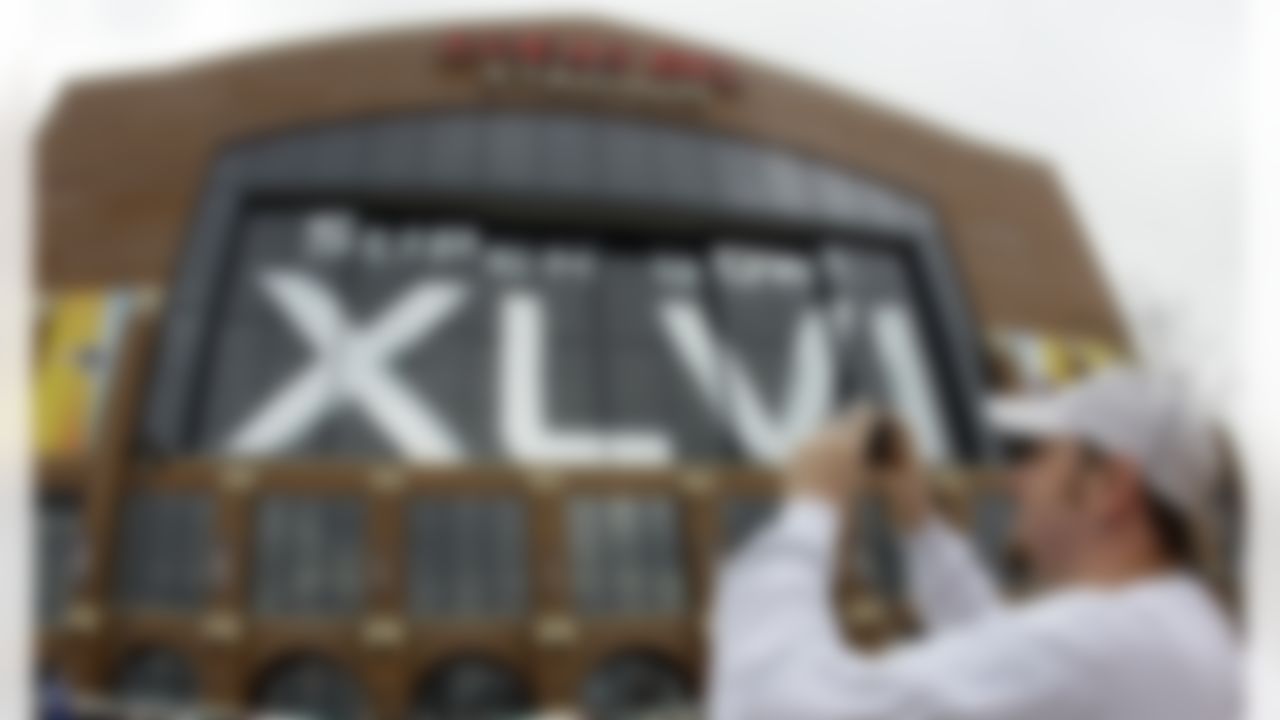 Chris Simpson takes a picture of Lucas Oil Stadium after Media Day for NFL football's Super Bowl XLVI Tuesday, Jan. 31, 2012, in Indianapolis. (AP Photo/Mark Humphrey)