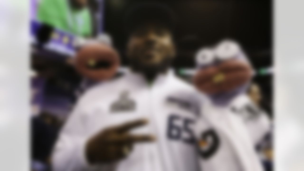 Seattle Seahawks' Patrick Lewis poses with puppets during media day for NFL Super Bowl XLIX football game Tuesday, Jan. 27, 2015, in Phoenix. (AP Photo/Mark Humphrey)
