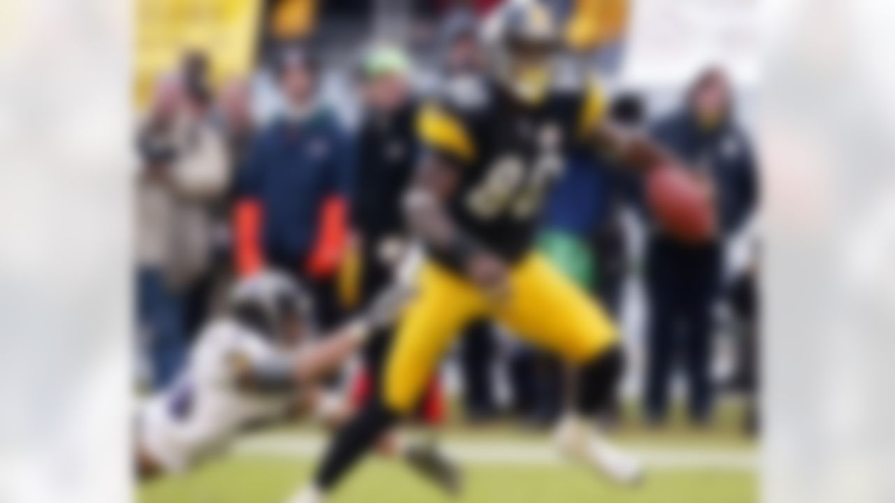 Pittsburgh Steelers wide receiver Plaxico Burress (80) breaks the tackle of Baltimore Ravens safety Rod Woodson on a touchdown reception in the fourth quarter of an AFC divisinal playoff game Sunday, Jan. 20, 2002, in Pittsburgh. (AP Photo/Rusty Kennedy)