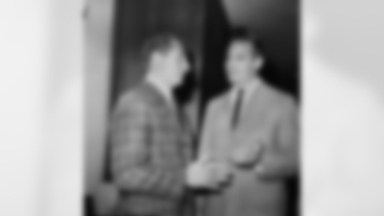 Sam Huff, right, New York Giants veteran linebacker, chats with his coach, Allie Sherman, in New York on Jan. 29, 1963 at a sports award luncheon they attended as guests. The bone-rattling personal feud between Huff and Green Bay Packers fullback Jim Taylor which marked the National Football League title game on December continues to boil in a battle of words. Huff says the hard-fought game, won by the Packers, 16-7, has brought a cascade of letters from fans accusing him of rough tactics. (AP Photo/Harry Harris)