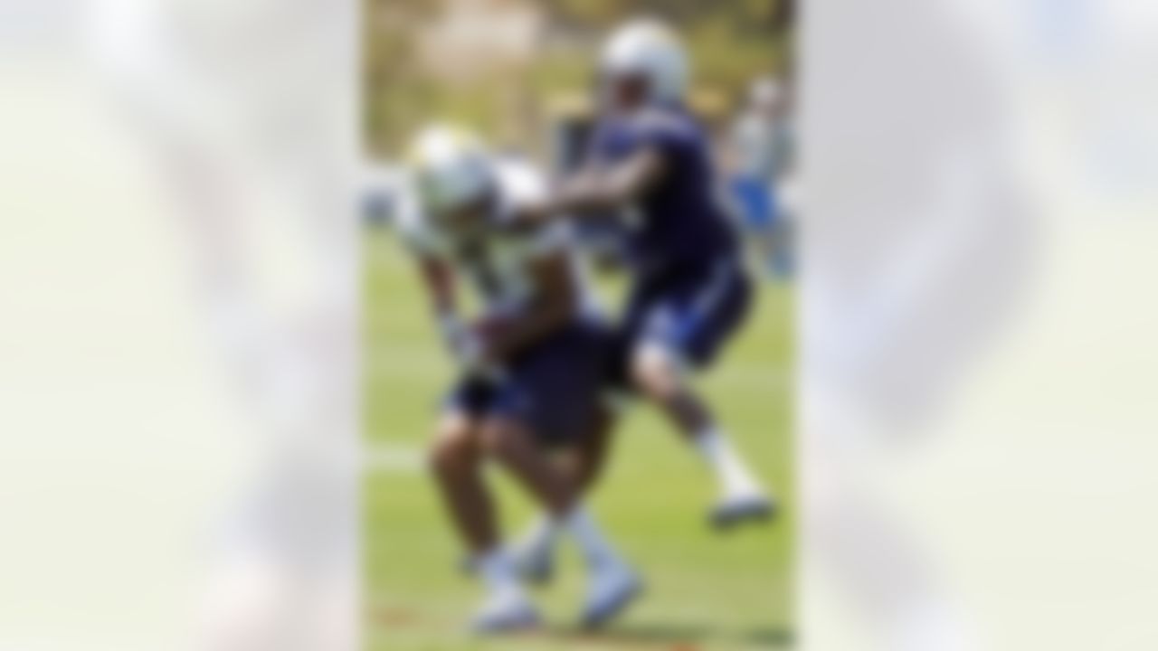 San Diego Chargers wide receiver Phillip Payne pulls in a pass as cornerback Gregory Gatson grabs his face mask during NFL football practice at team's training camp, Tuesday, July 24, 2012, in San Diego. (AP Photo/Lenny Ignelzi)
