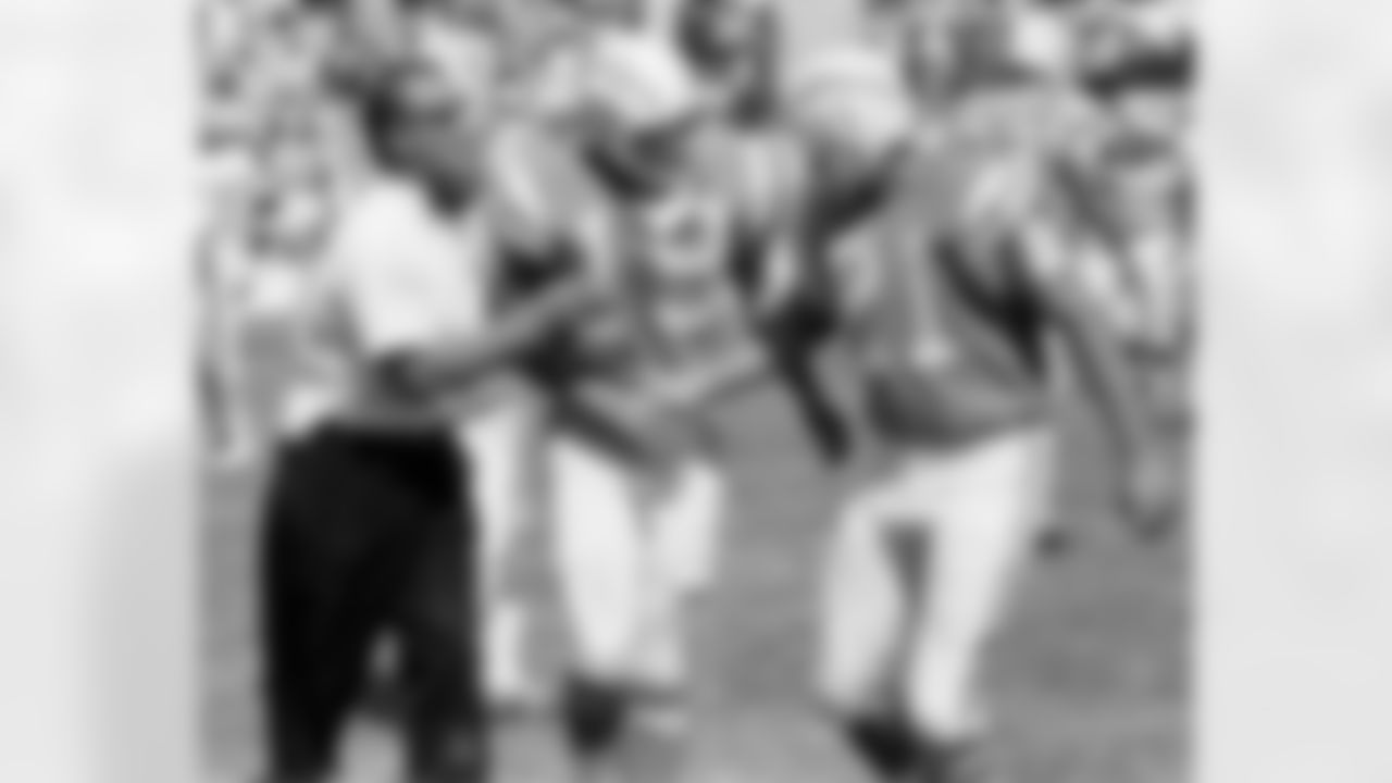 San Diego Chargers head coach Sid Gillman congratulates flanker Lance Alworth (19) and quarterback John Hadl (21) following a 31-14 victory over the Houston Oilers on October 3, 1965, at Balboa Stadium in San Diego, California. (Photo by Charles Aqua Viva/NFL)