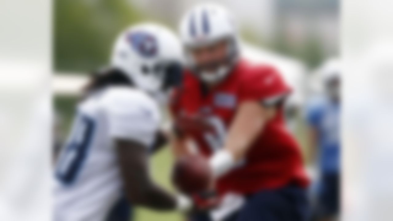 Tennessee Titans quarterback Matt Hasselbeck (8) hands the ball off to running back Chris Johnson (28) during NFL football training camp at the team's headquarters, Monday, July 30, 2012, in Nashville, Tenn. (AP Photo/Wade Payne)