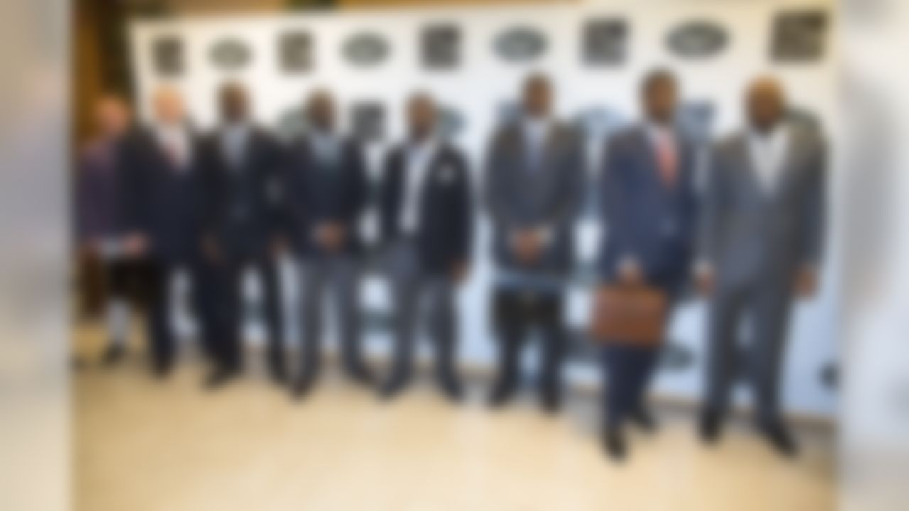 (left to right) The New York Jets' Nick Folk, Mike DeVito, Stephen Hill, Demario Davis, Bart Scott, D'Brickashaw Ferguson, Quinton Coples, and Calvin Pace pose for a photograph during a charity fashion show on Monday, November 26, 2012, in Short Hills, N.J. Saks Fifth Avenue and the New York Jets have partnered for the event where a portion of the evening's sales will be donated to the Jets Foundation. (John Minchillo/AP Images for NFL)