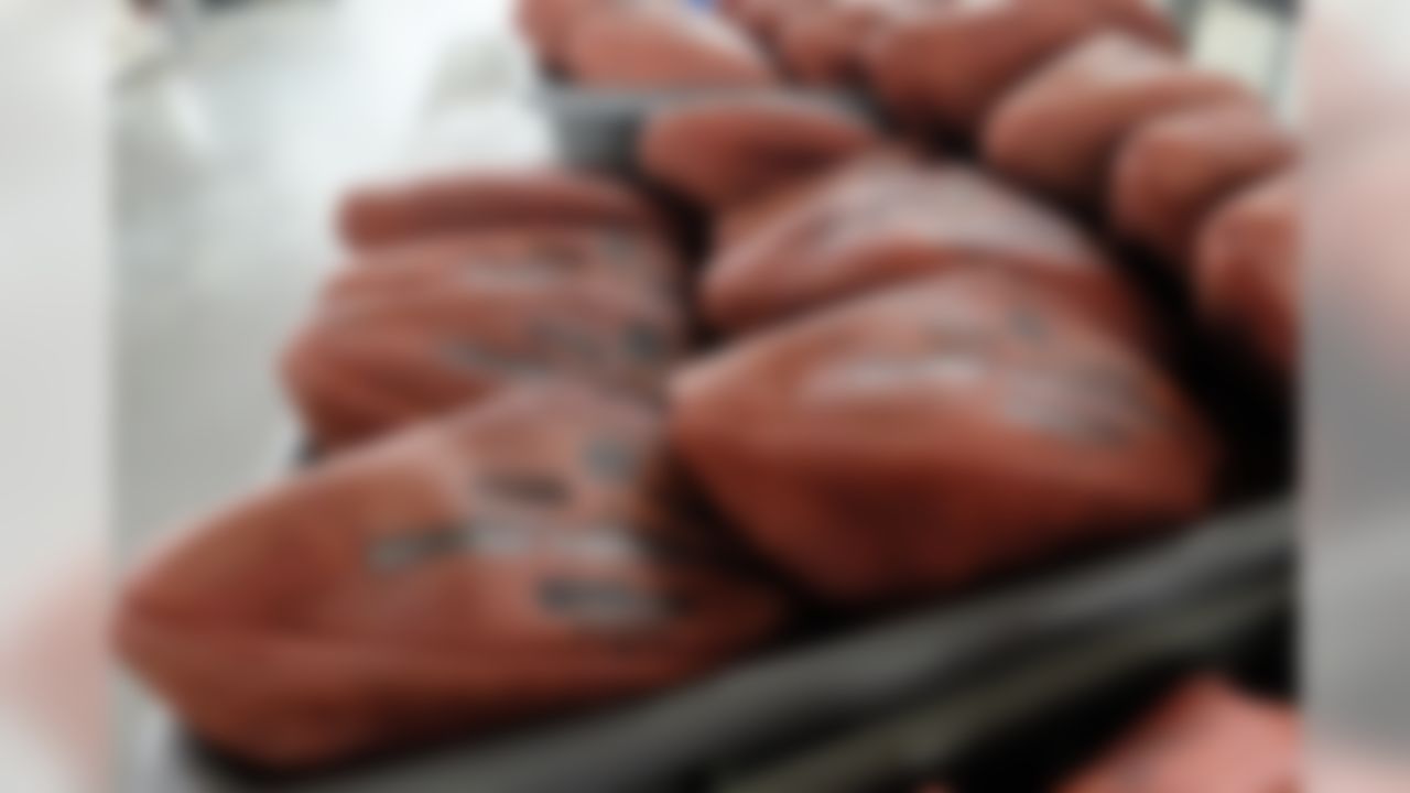 Official game balls for NFL football's Super Bowl XLIX sit in a bin before being laced and inflated at the Wilson Sporting Goods Co. in Ada, Ohio, Tuesday, Jan. 20, 2015. The New England Patriots will play the Seattle Seahawks for the NFL championship on Sunday, Feb. 1, 2015,  in Glendale, Ariz. (AP Photo/Rick Osentoski)