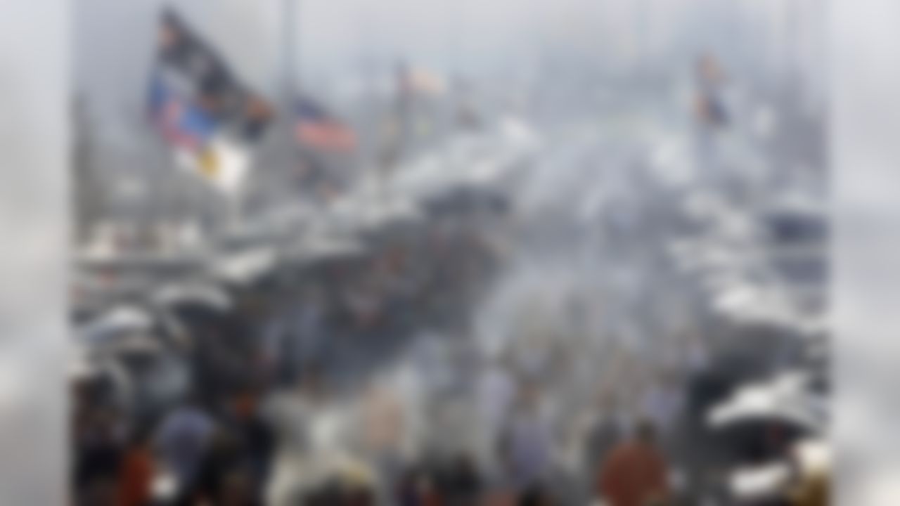 Tailgaters appear in the smoked-filled parking area outside Soldier Field on an unseasonably warm day before an NFL football game between the Chicago Bears and Arizona Cardinals in Chicago, Sunday, Nov. 8, 2009. (AP Photo/Charles Rex Arbogast)