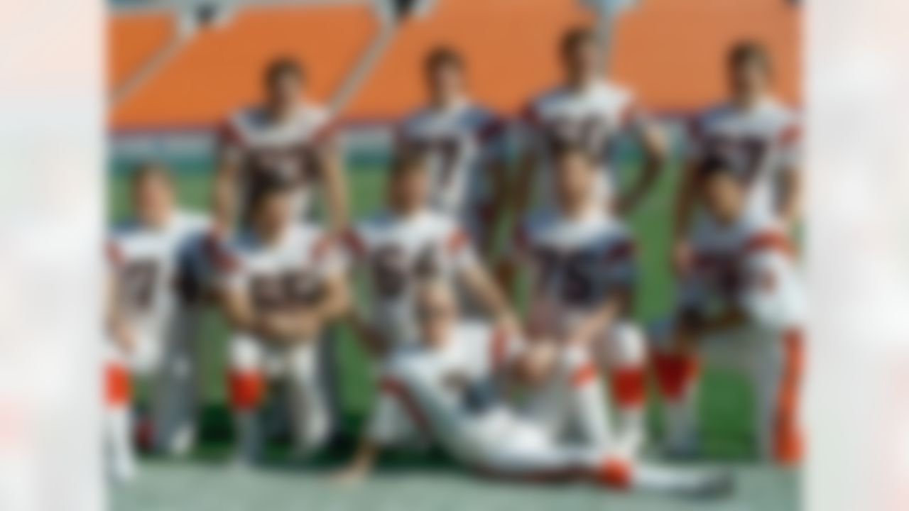 Cincinnati Bengals quarterback Boomer Esiason (7) poses with the Bengals offensive line in Miami as they turn out for Super Bowl Media Day on Tuesday, Jan. 17, 1989. From left, back row: Joe Walter (63), Herb Wester (77), Dave Smith (60), David Douglas (67). Front row: Brian Blados (74), Max Montoya (65), Bruce Kozerski (64), Bruce Reimers (75), Anthony Munoz (78). (AP Photo/Al Behrman)