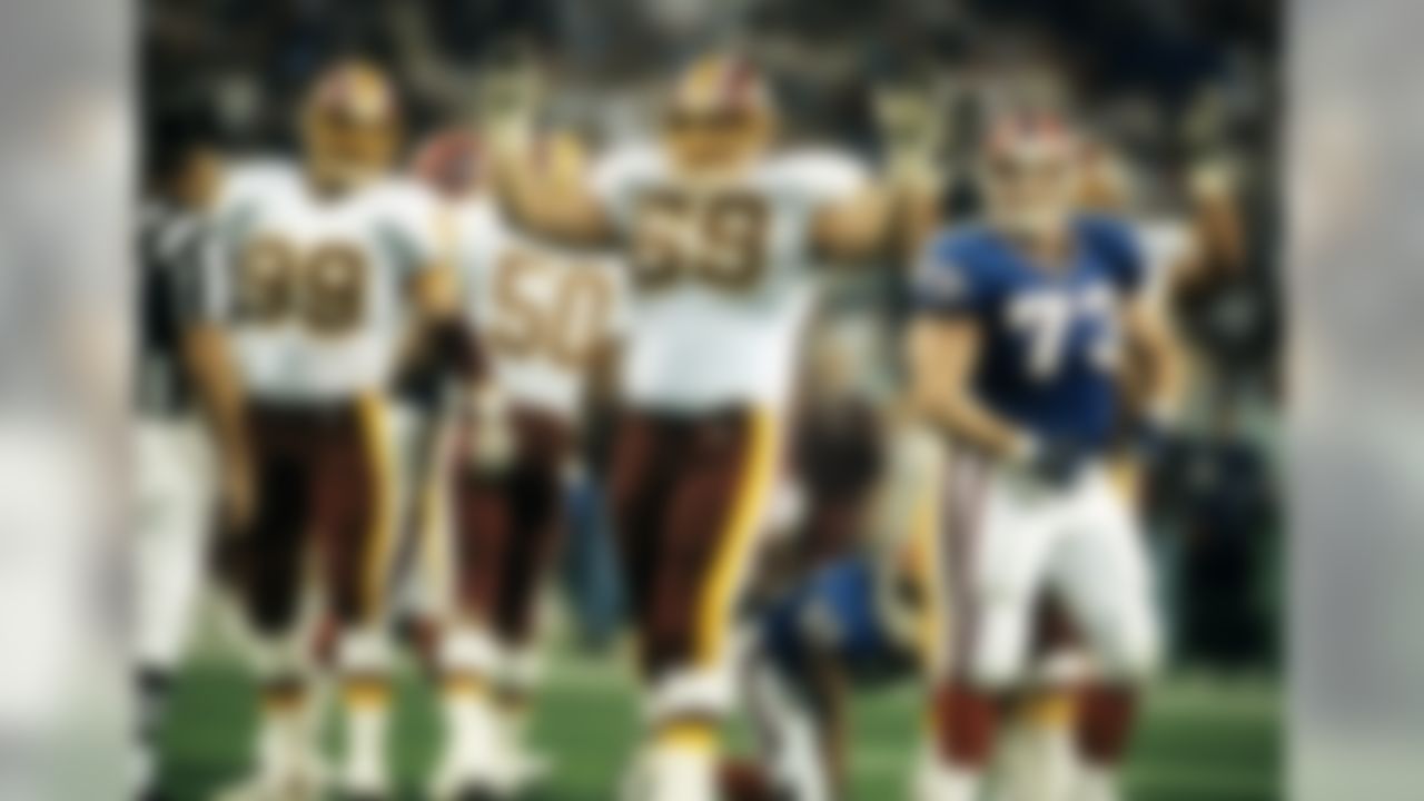 Buffalo Bills defensive tackle Mike Lodish looks on as Washington Redskins guard Mark Schlereth celebrates a touchdown carry by running back Gerald Riggs during Super Bowl XXVI on January 26, 1992, at the Hubert H. Humphrey Metrodome in Minneapolis, Minnesota. (AP Photo/Al Messerschmidt)