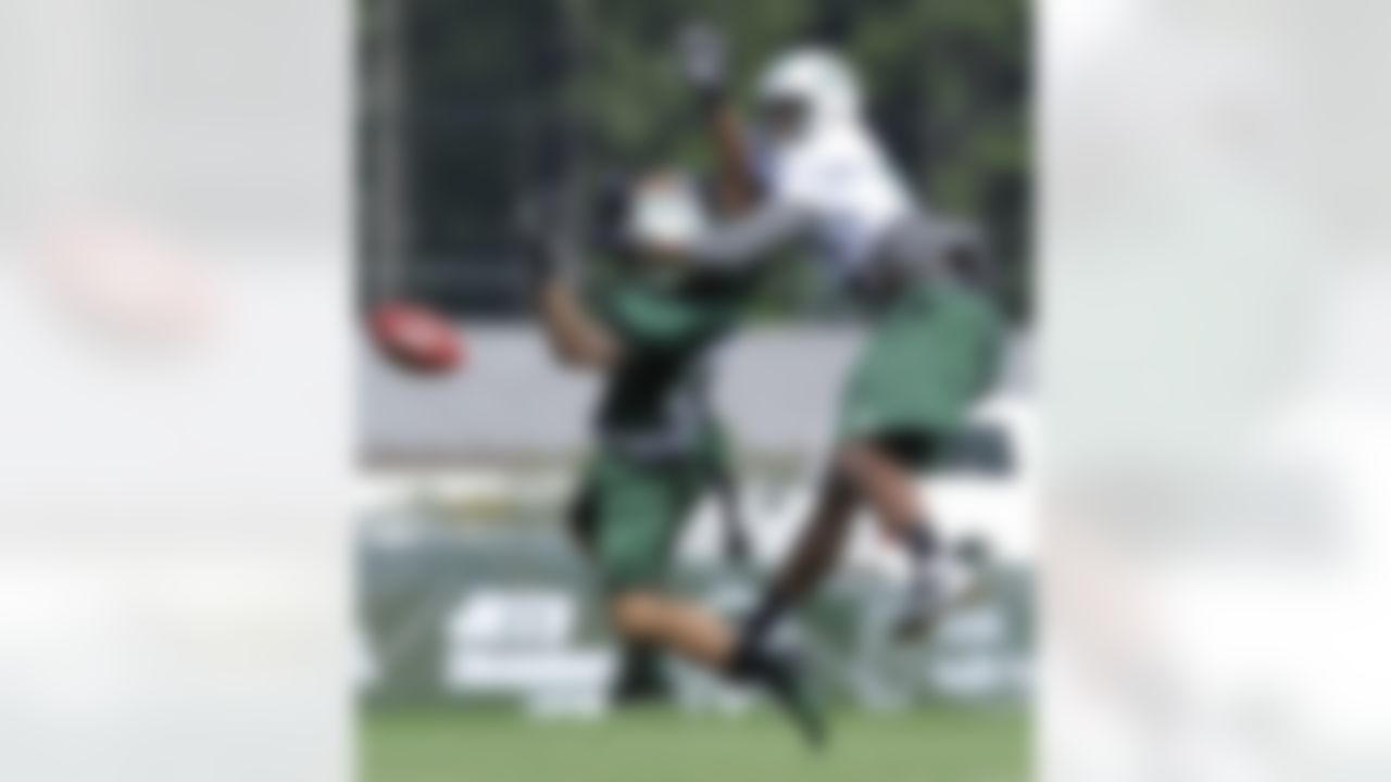 New York Jets cornerback Ellis Lankster, left, breaks up a pass intended for wide receiver Stephen Hill on opening day of their NFL football training camp Friday, July 27, 2012, in Cortland, N.Y. (AP Photo/Bill Kostroun)