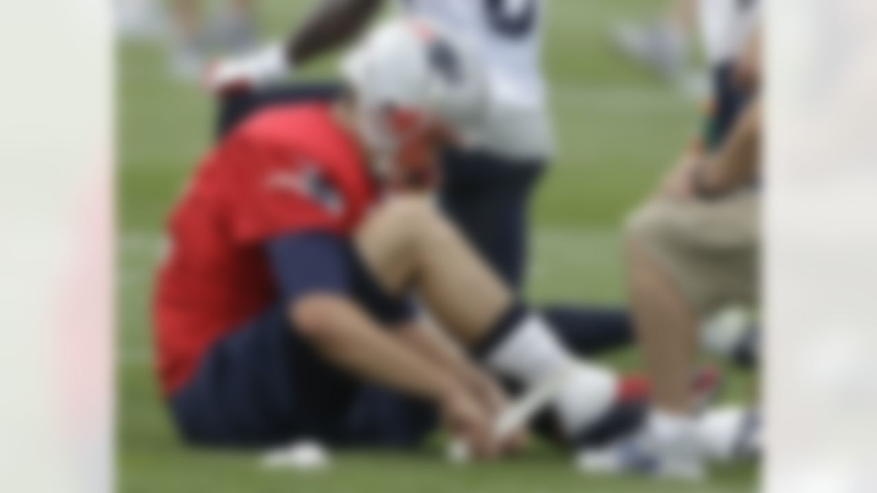 New England Patriots quarterback Tom Brady tapes his right ankle during practice on the second day of NFL football training camp in Foxborough, Mass., Friday, July 27, 2012. (AP Photo/Stephan Savoia)