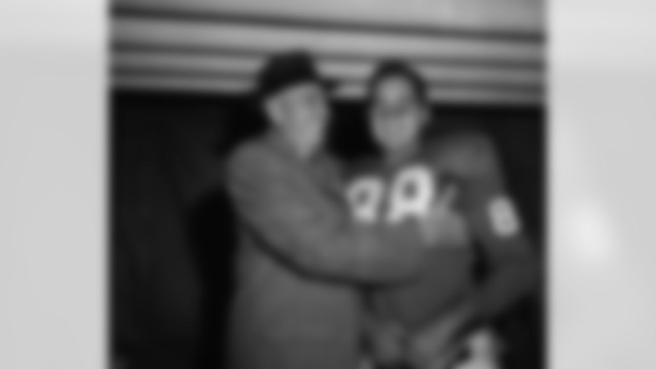 New York Giant coach Jim Lee Howell hugs Allen Pat Summerall in dressing room of Yankee Stadium after Giants defeated Baltimore Colts 24-21 in New York on Nov. 9, 1958. Summerall, with less than 3 minutes to play in game kicked 28-yard field goal to provide winning margin in the game. (Associated Press)