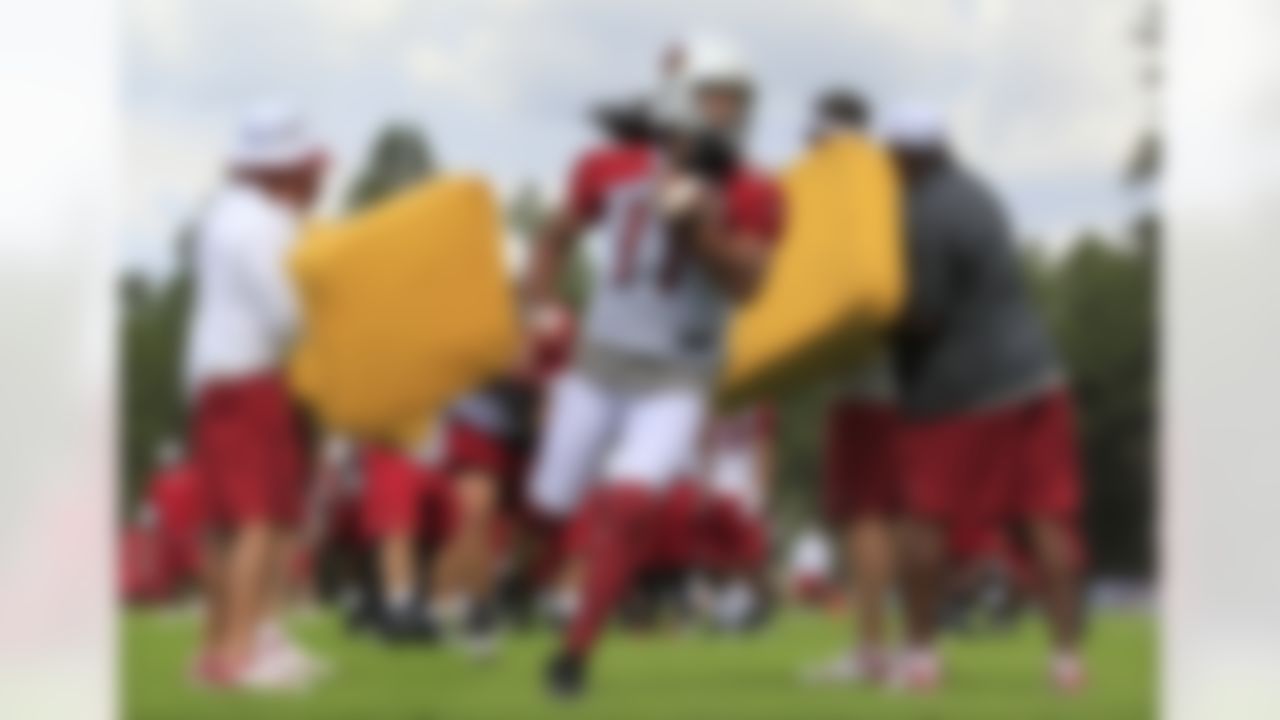 Arizona Cardinals' Larry Fitzgerald, center, runs drills with teammates and coaches during the first day of NFL training camp football practice at Northern Arizona University, Wednesday, July 25, 2012, in Flagstaff, Ariz. (AP Photo/Ross D. Franklin)