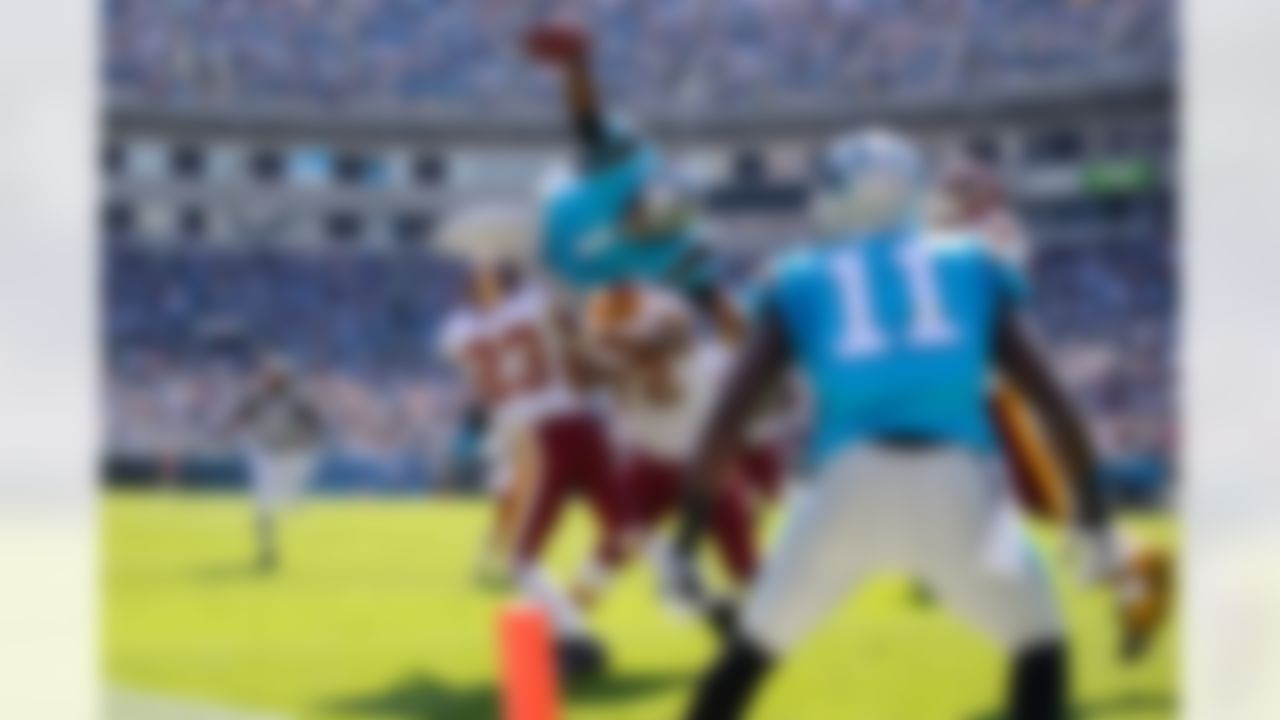 Carolina Panthers quarterback Cam Newton (1) is stopped by Washington Redskins cornerback DeAngelo Hall (23) and defensive end Stephen Bowen (72) as he dives for the end zone during an NFL football game in Charlotte, North Carolina, Sunday, October 23, 2011.