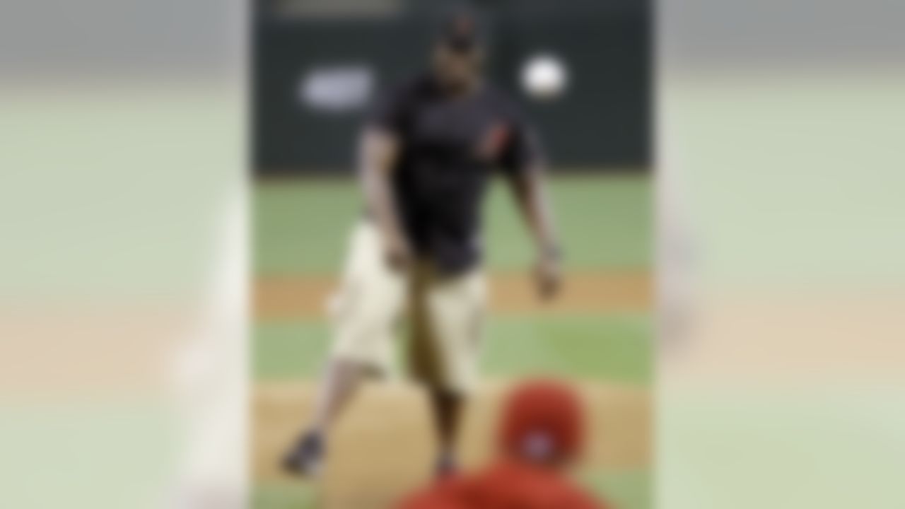 Arizona Cardinals football team's first-round NFL draft pick Jonathan Cooper throws out the ceremonial first pitch before the Arizona Diamondbacks and the Colorado Rockies play a baseball game on Friday, April 26, 2013, in Phoenix. (AP Photo/Matt York)