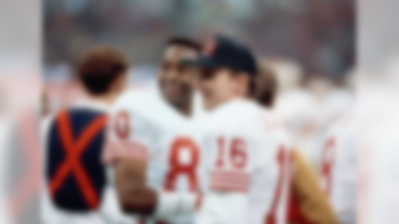 San Francisco 49ers quarterback Joe Montana (16) chats with wide receiver Jerry Rice late in Sunday, Jan. 29, 1990 Super Bowl thrashing of the Denver Broncos, 55-10. Rice caught three of Montana's five touchdown passes in the game at New Orleans. (AP Photo/Lennox McLendon)
