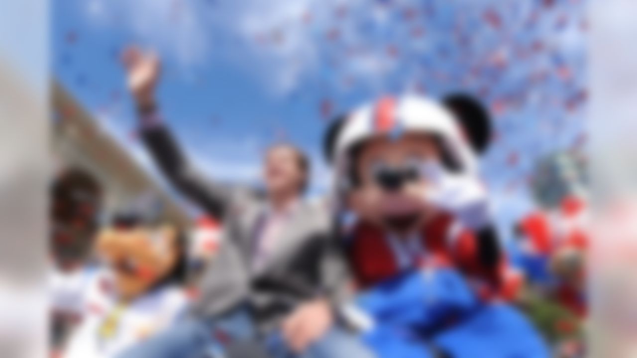 In this Monday, Feb. 8, 2010 photo released by Disney, Super Bowl XLIV MVP, New Orleans Saints quarterback Drew Brees joins Mickey Mouse in a parade in the Magic Kingdom in Lake Buena Vista, Fla., celebrating the Saints' 31-17 victory over the Indianapolis Colts in Sunday's Super Bowl. (AP Photo/Disney, David Roark)