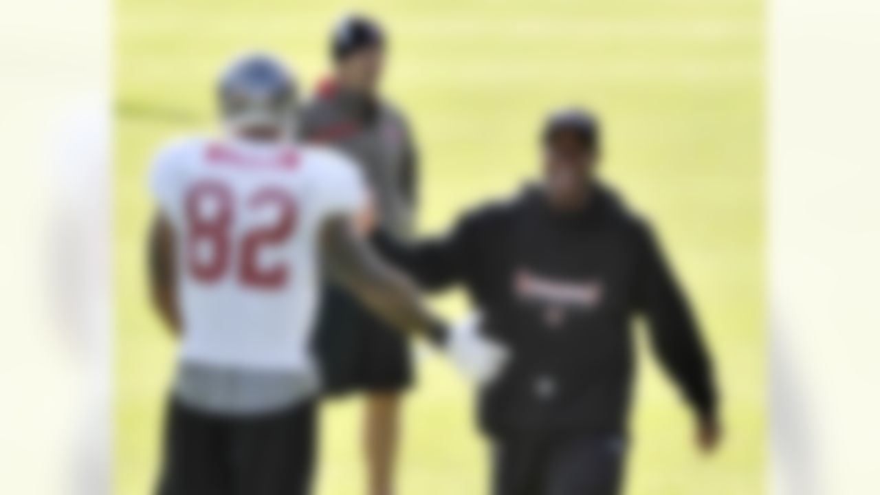 Tampa Bay Buccaneers head coach Raheem Morris shares a joke with tight end Kellen Winslow during practice at Pennyhills Park in Surrey, England on October 20, 2011. (Sean Ryan/NFL)